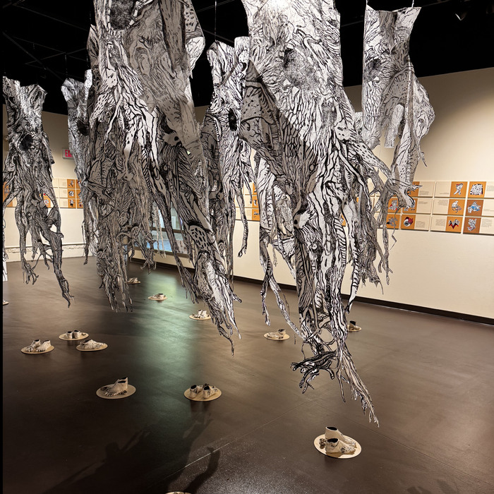 Candace Garlock, Never Out of the Woods (alt view), wood relief prints on mulberry paper, porcelain casts, resin, 8' x 20' x 12', NFS