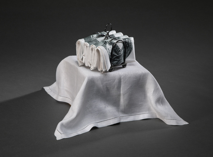 Linda Craighead, Tea for Four, photopolymer etching on Damask napkins, silver toast holder, 12" x 7" x 7", NFS